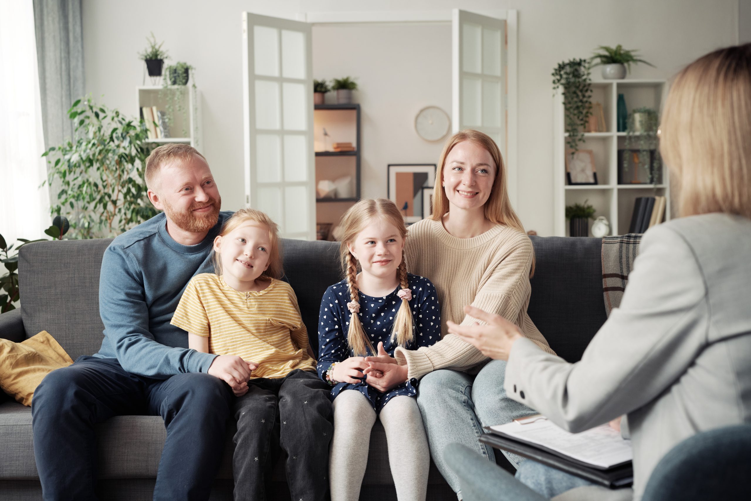 Social worker talking to adoptive family at home